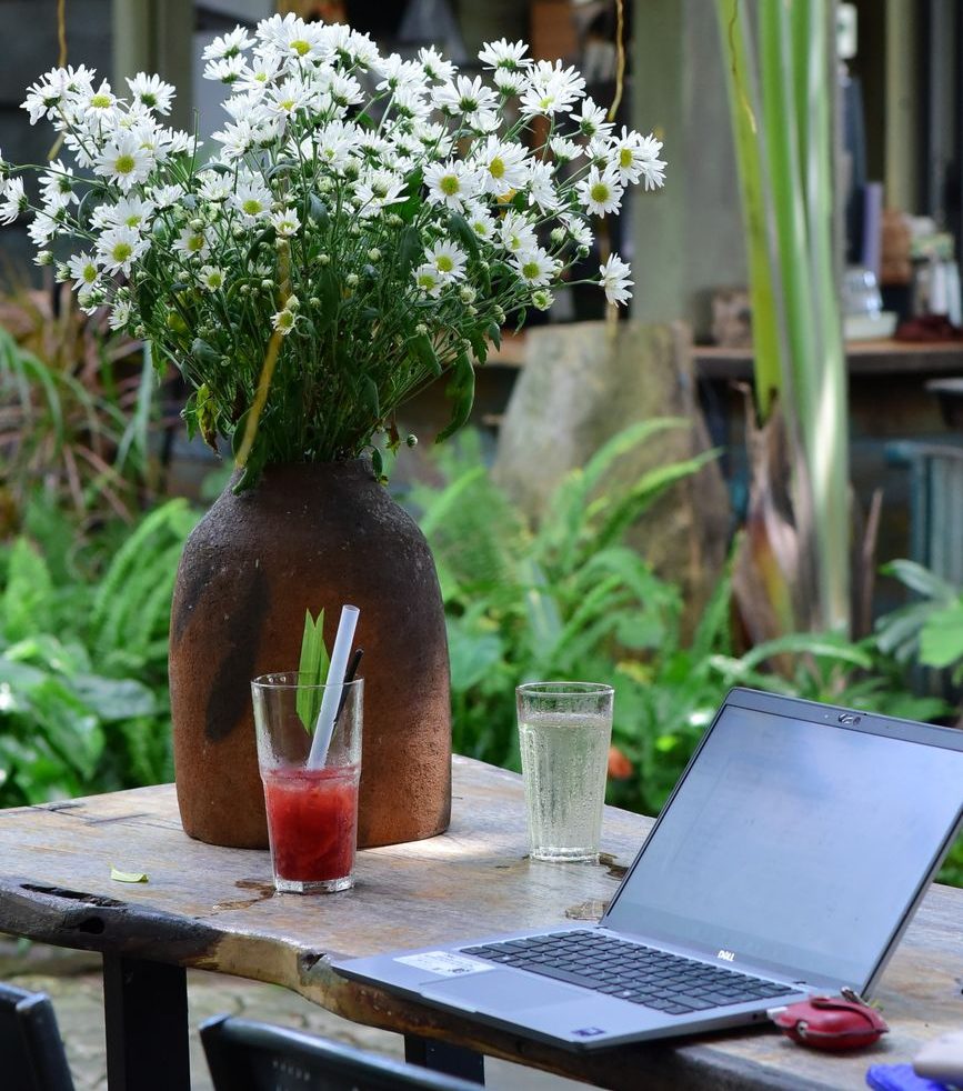outdoor workspace with flowers and drinks
